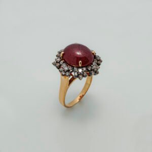 A Ring with Cabochon Ruby and zircons